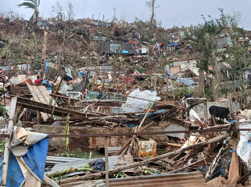 Cyclone-ravaged hillside in Mayotte, showing extensive damage to homes and infrastructure.