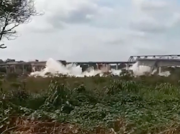 Water surging over a dam.