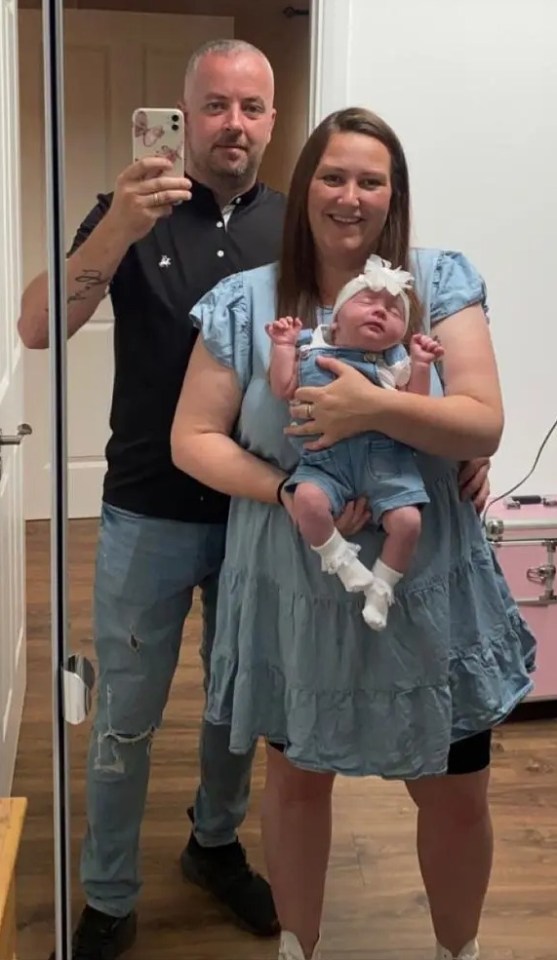 Parents holding their newborn baby.