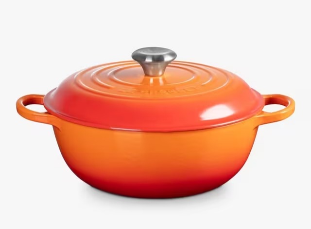 Orange enameled cast iron pot with lid.