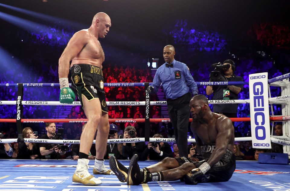 Tyson Fury knocks down Deontay Wilder in a boxing match.