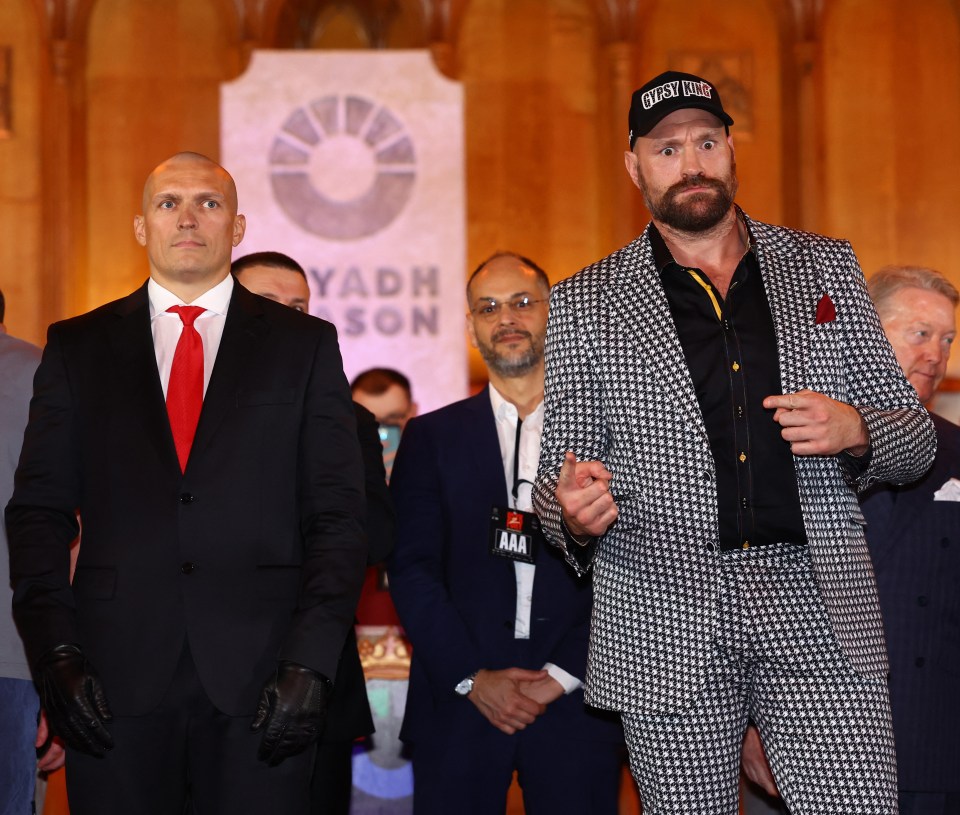 Oleksandr Usyk and Tyson Fury at a press conference.