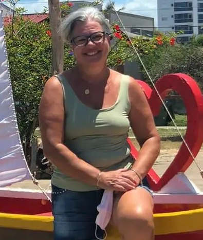 Woman sitting on a small sailboat.