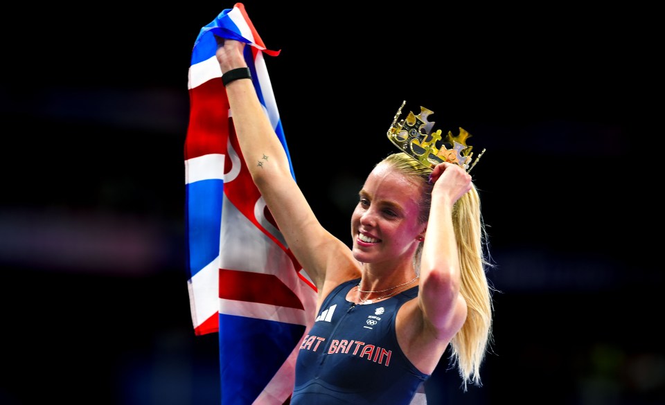 Keely Hodgkinson celebrates winning the Women's 800m Final, holding a British flag and a crown.