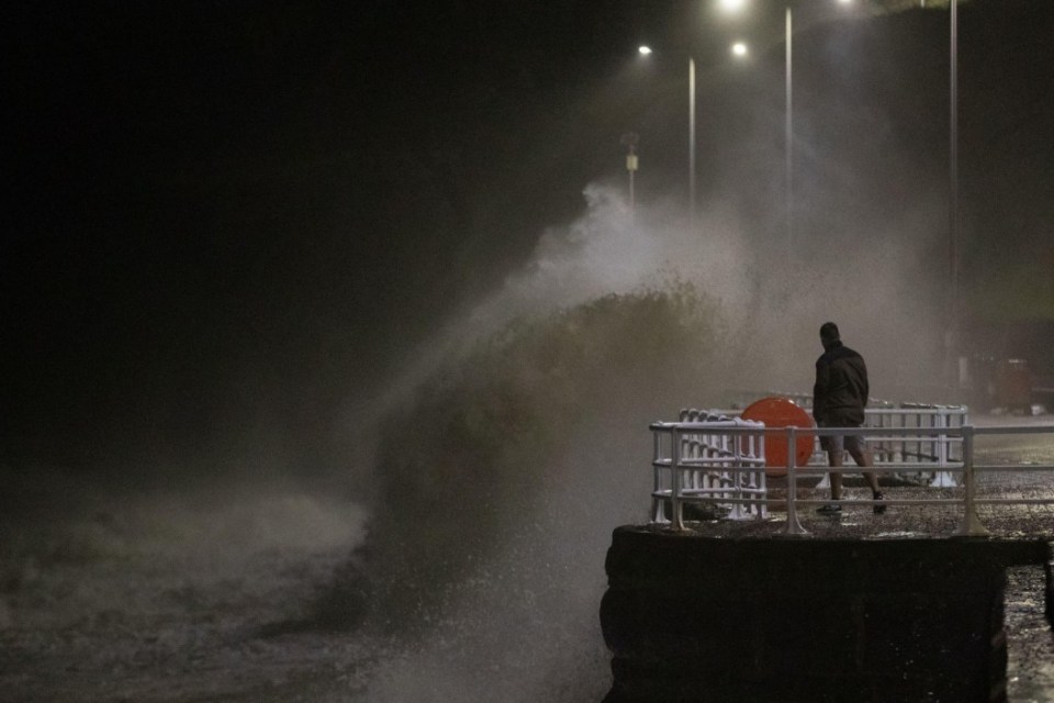 Alamy Live News. 2YTA41G Aberystwyth, Ceredigion, Wales, UK. 06th December 2024 UK Weather: A person watching the crashing waves along Aberystwyth promenade as the wind Strengthens from storm Darragh tonight. ¿ Ian Jones/Alamy Live News This is an Alamy Live News image and may not be part of your current Alamy deal . If you are unsure, please contact our sales team to check.