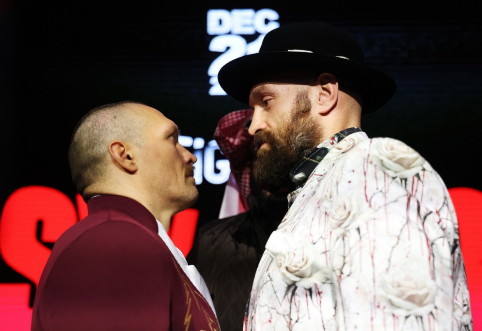 Oleksandr Usyk and Tyson Fury face off at a press conference.