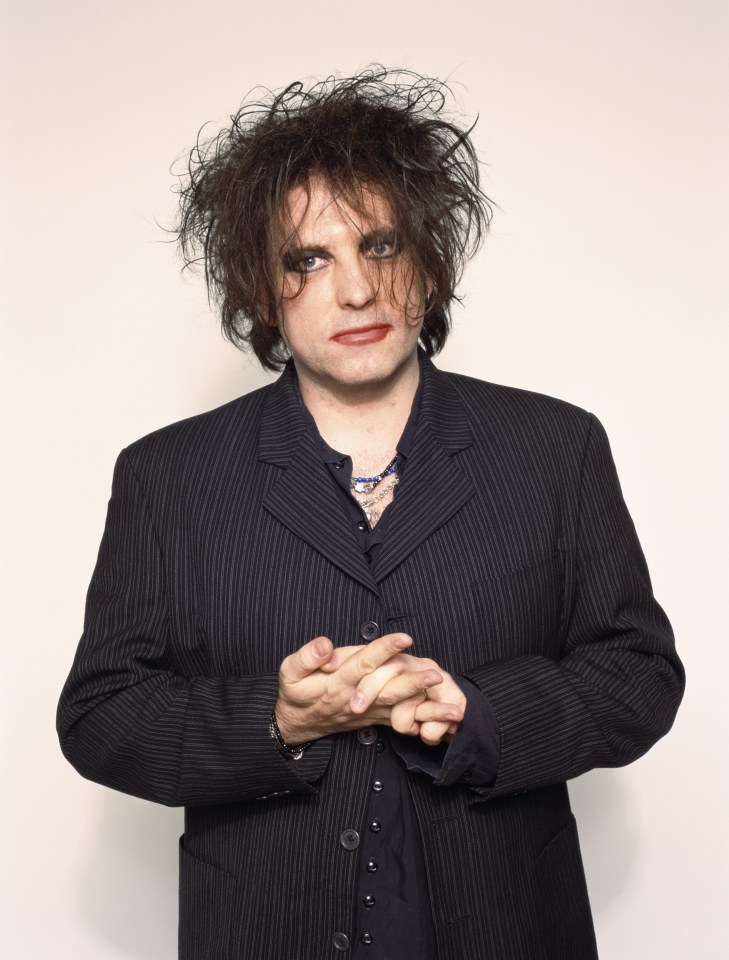 Robert Smith of The Cure in a pinstripe suit.