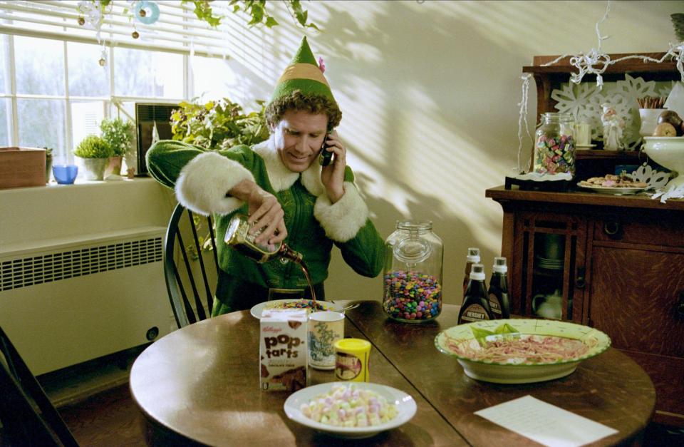 Will Ferrell as Buddy Hobbs in Elf, pouring syrup on his breakfast.