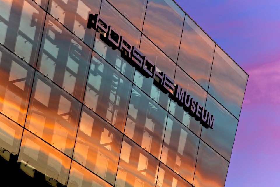 Porsche Museum exterior reflecting sunset.
