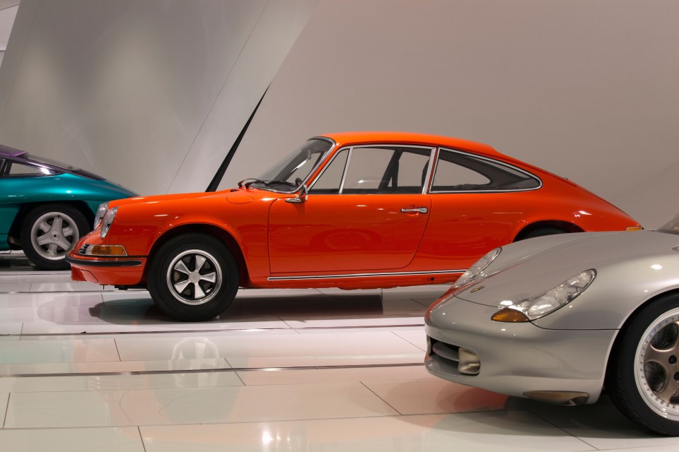 Orange Porsche 911 in a museum.