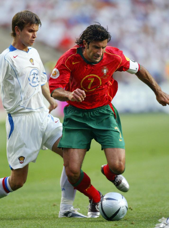 Luis Figo (right) vies for the ball during a soccer match.