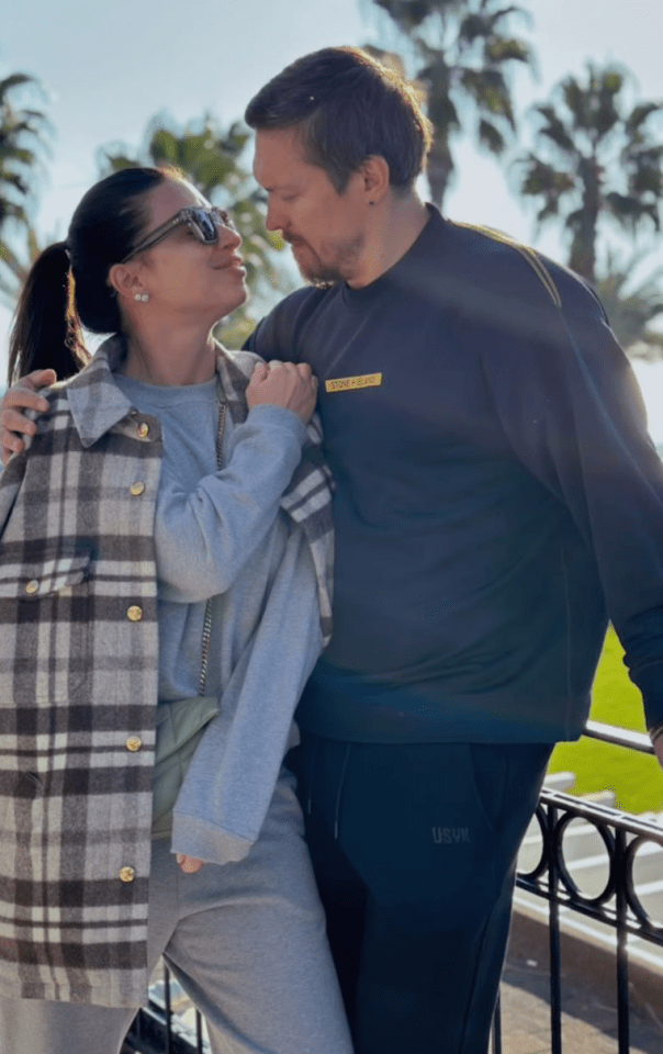Couple embracing outdoors.