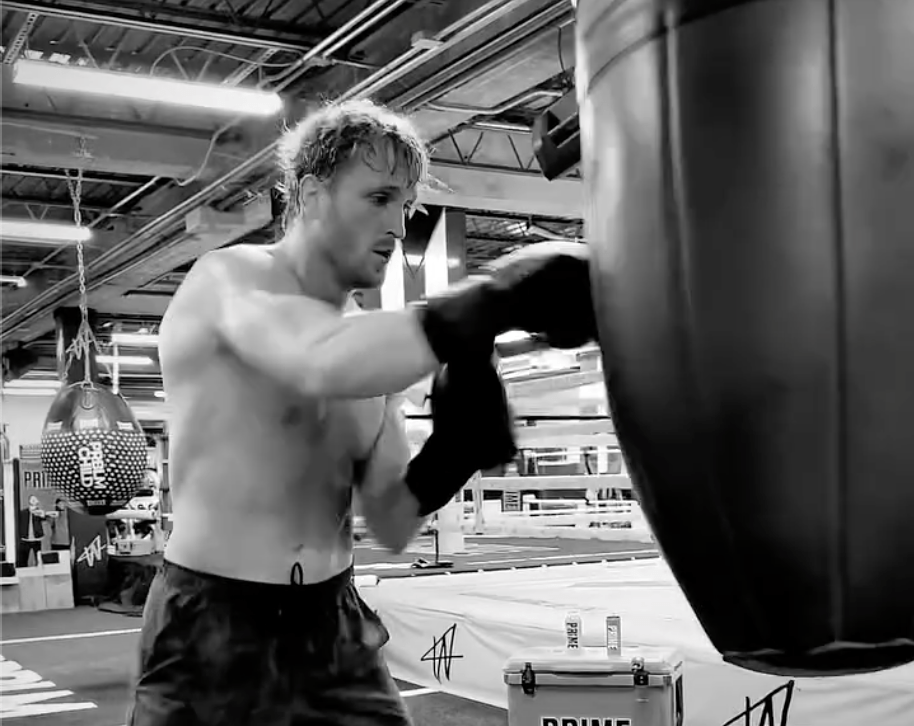 Man shadow boxing heavy bag.