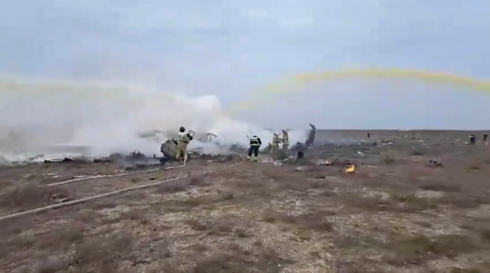 Firefighters extinguishing a burning airplane after an emergency landing.