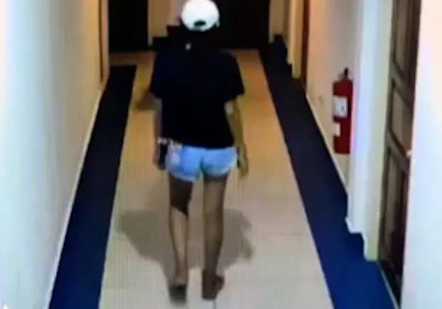 CCTV footage of a man and woman walking down a hotel corridor.