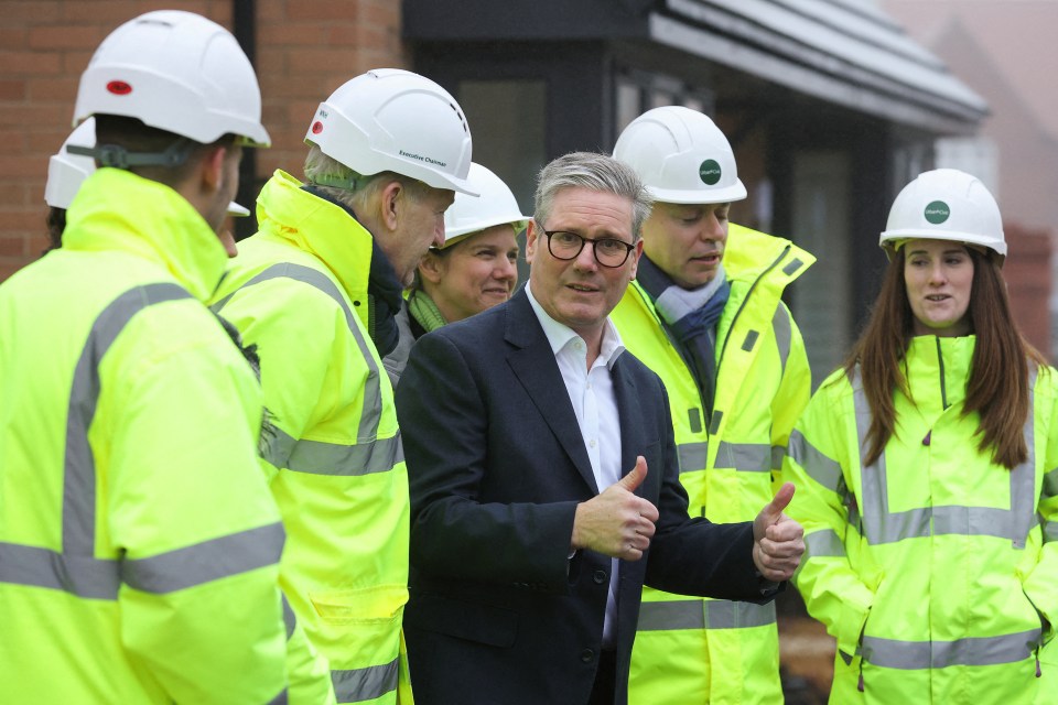 Prime Minister Keir Starmer giving a thumbs-up at a construction site.