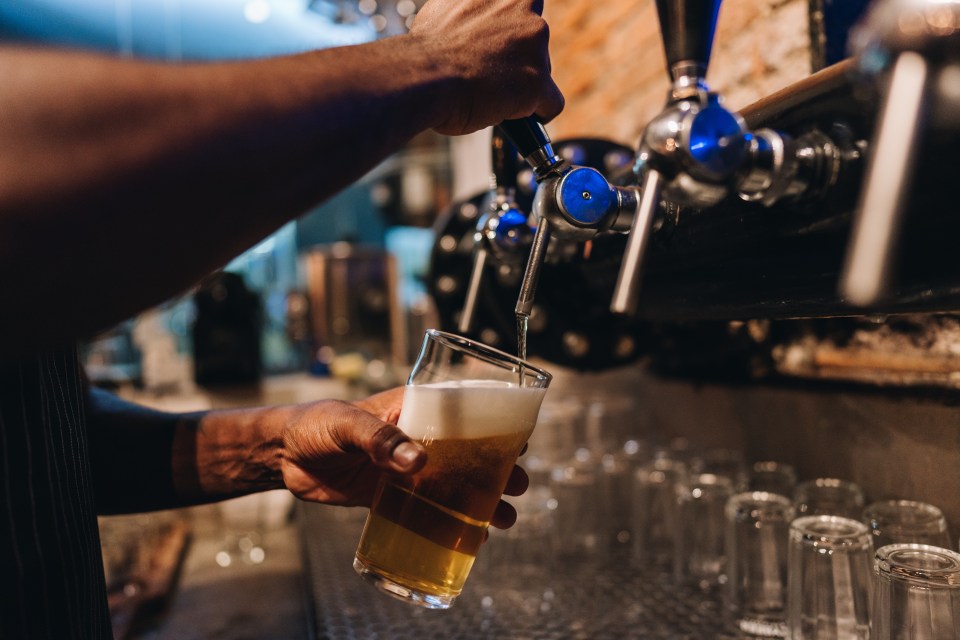 Bartender pouring a beer.