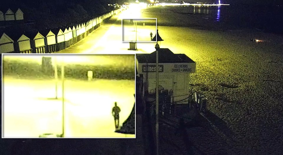 CCTV footage of a man walking along a Bournemouth seafront promenade at night.