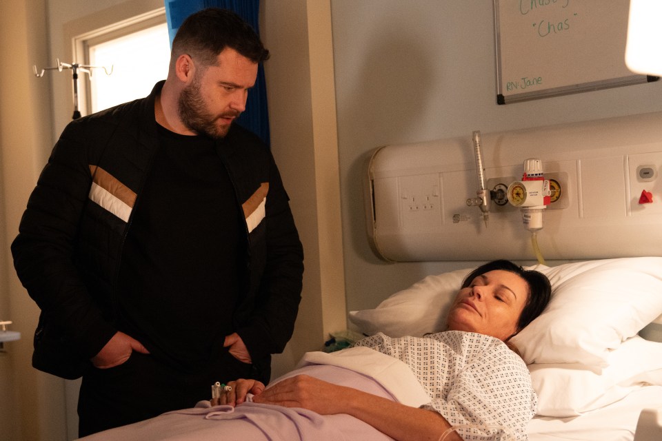 Chas Dingle in a hospital bed, with Aaron Dingle standing beside her.