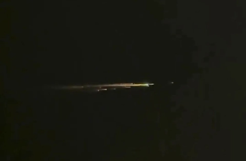 Chinese spaceship breaking apart in the night sky.