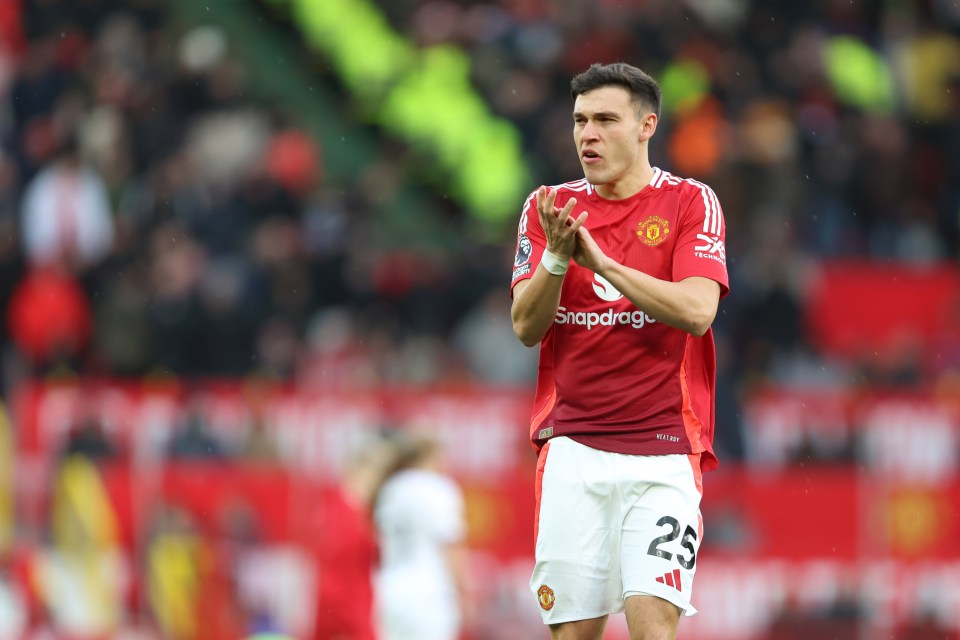 Manuel Ugarte of Manchester United applauding during a Premier League match.