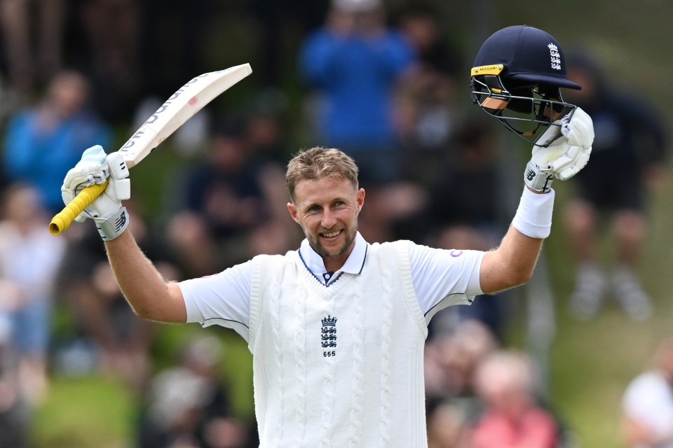 Joe Root celebrates scoring a century in a cricket match.