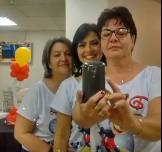 Three women take a selfie video.