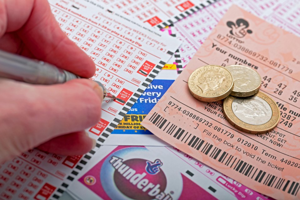 Close-up of a person filling out a National Lottery ticket.