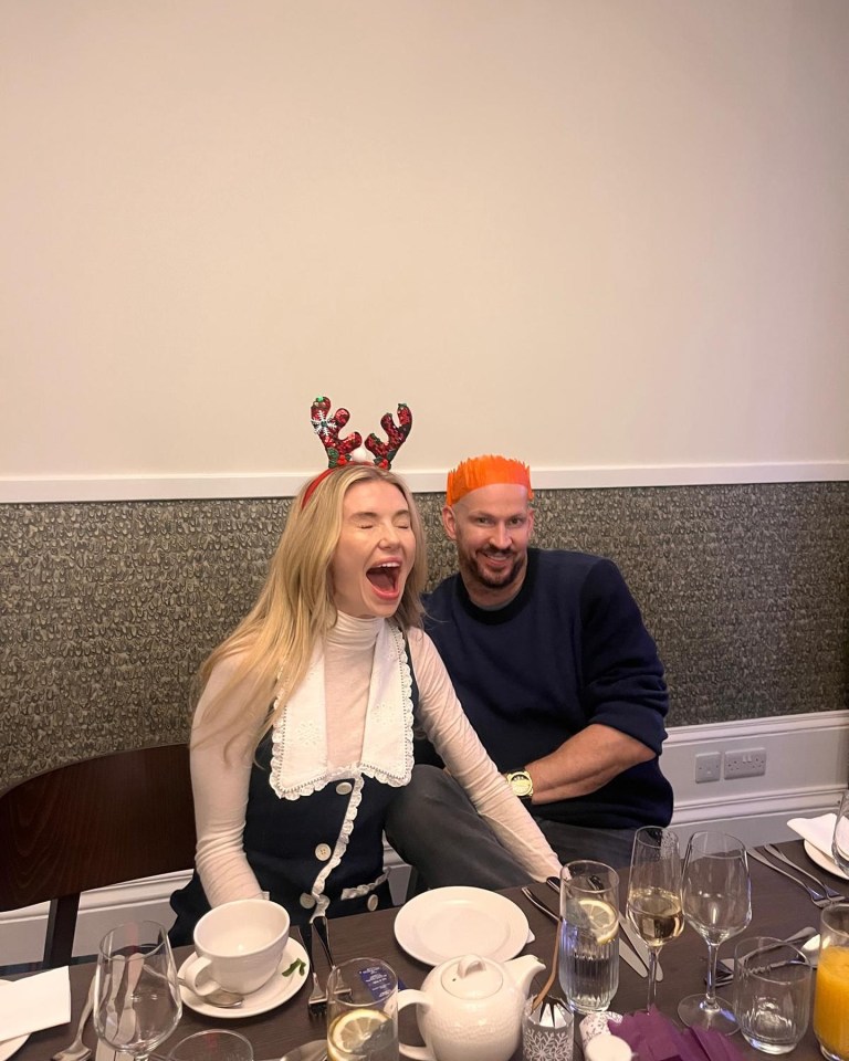 Georgia Toffolo and her fiancé, James Watt, wearing festive headwear at a Christmas meal.