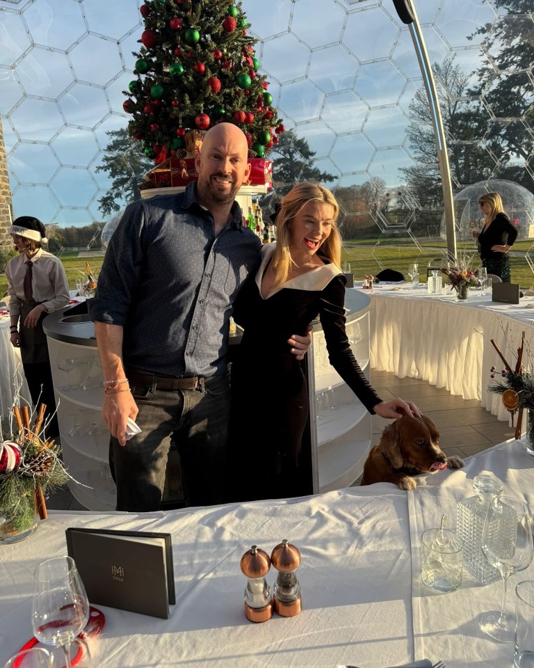 Georgia Toffolo and her fiancé at a Christmas celebration in a glass dome.