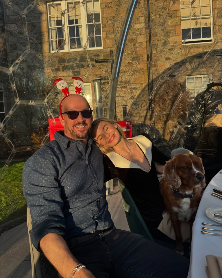 Georgia Toffolo and her fiancé James Watt with their dog at a Christmas dinner.