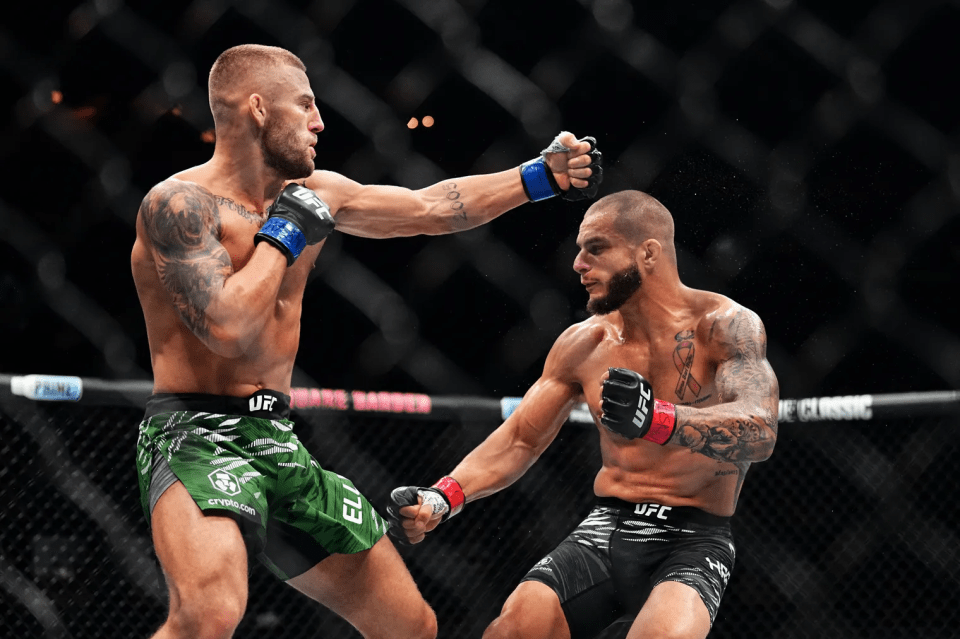 Two MMA fighters exchanging blows in a UFC match.