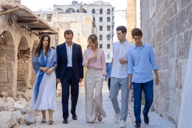 Family walking down a war-torn street.