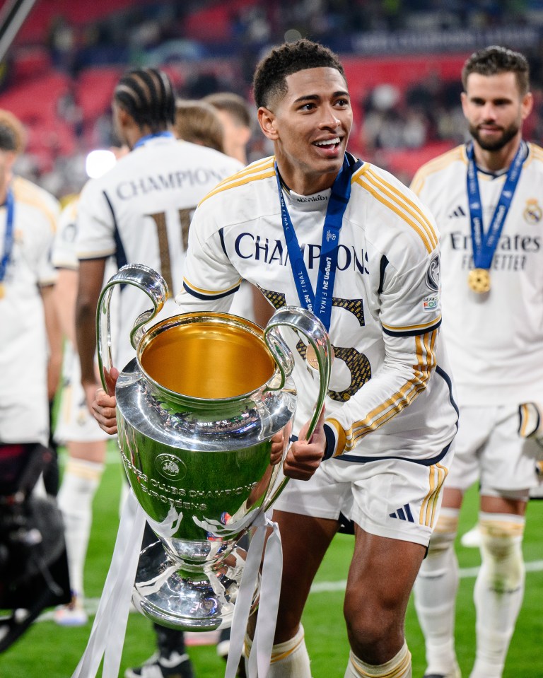 Jude Bellingham of Real Madrid holding the UEFA Champions League trophy.