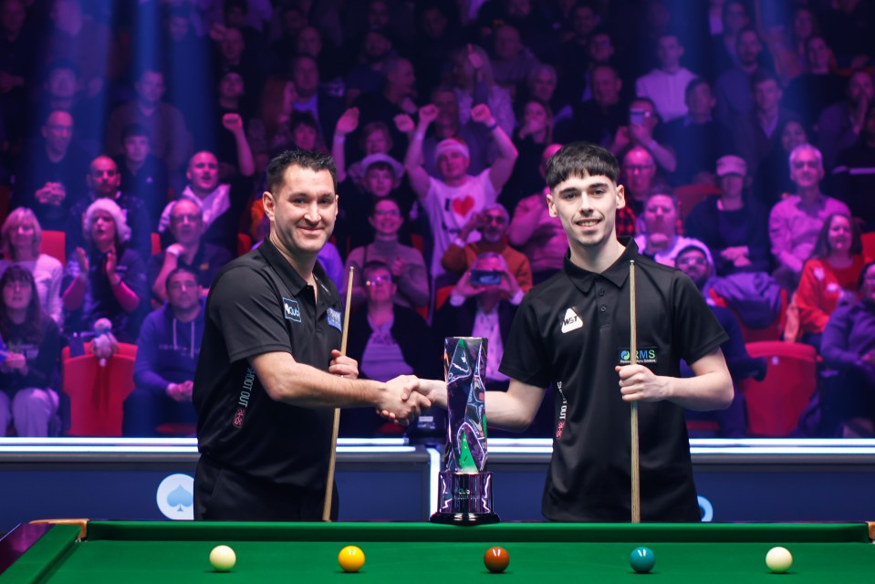 Tom Ford of England and Liam Graham of Scotland shake hands after a snooker match.