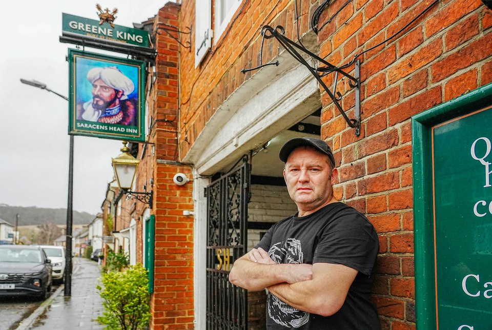 Landlord of the Saracens Head Inn standing outside the pub, which is facing legal action over its name.