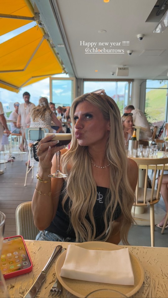 Chloe Burrows celebrating New Year's Eve with a cocktail.