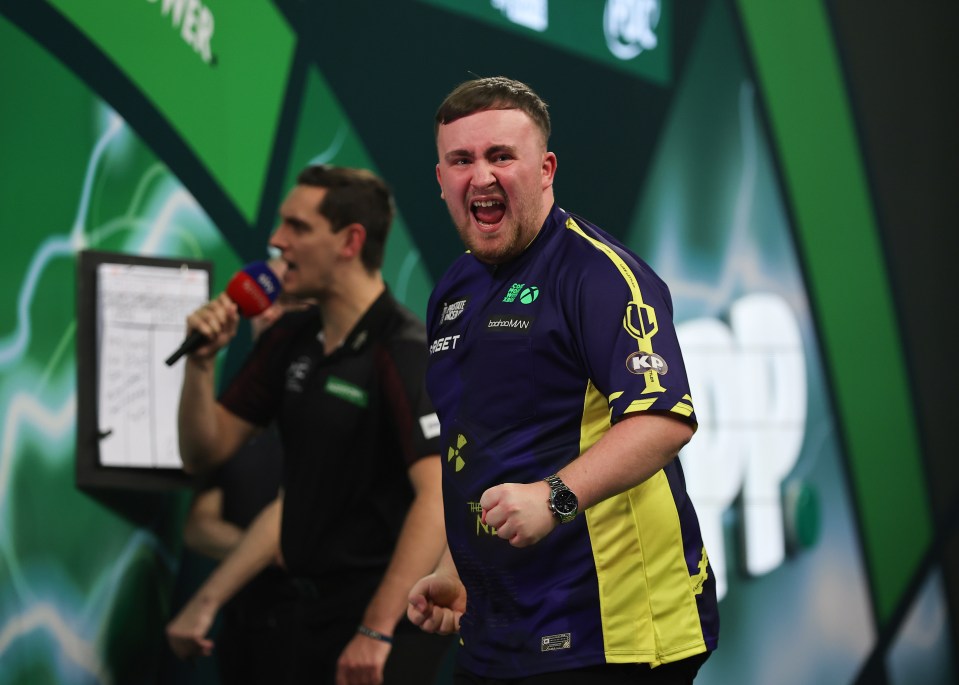 Luke Littler celebrates a darts victory.