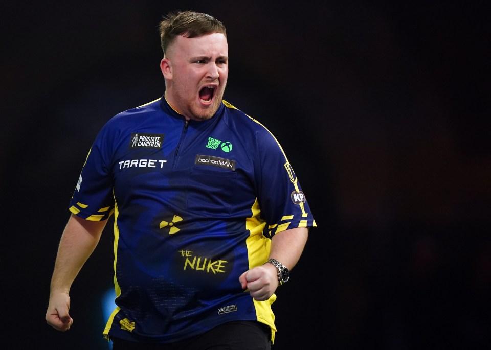 Darts player Littler celebrates a win over Meikle in the 2025 World Championship Round 2.