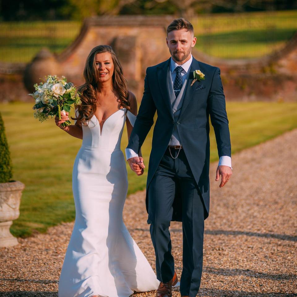Tayah and Adam, a newly engaged couple, walking hand-in-hand.