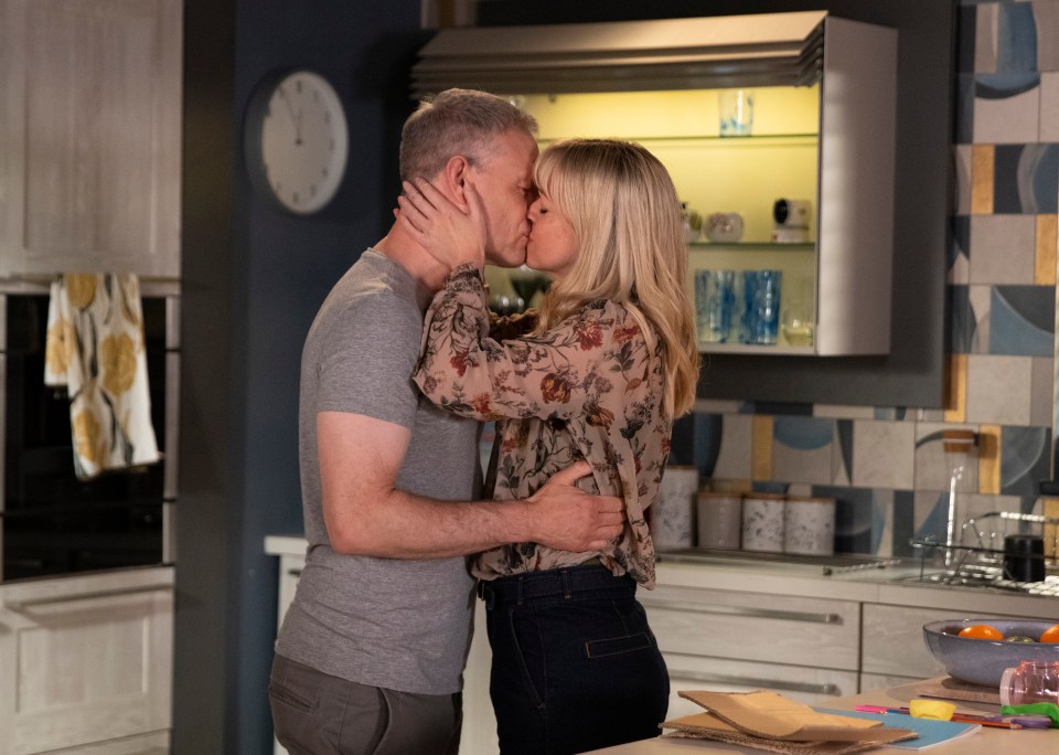 Nick and Toyah kissing in a kitchen.