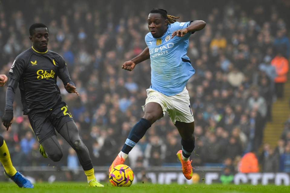Manchester City's Jeremy Doku dribbling the ball.