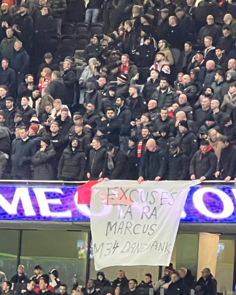 Manchester United fans hold a banner that reads "Excuses Ta Ra Marcus M34 Dane Jank".