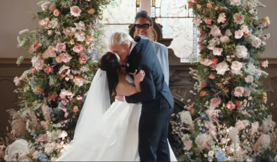 A bride and groom kissing at their wedding ceremony.