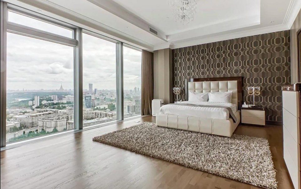 Luxury Moscow apartment bedroom with city view.