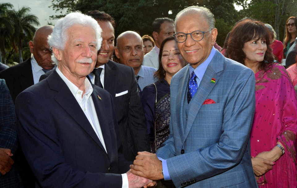 Mauritius' new prime minister, Navin Ramgoolam, shakes hands with Paul Berenger.