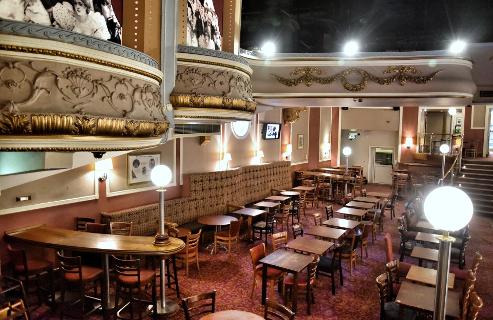 Interior view of The Palladium in Llandudno, showing tables and chairs in a Wetherspoon's pub.