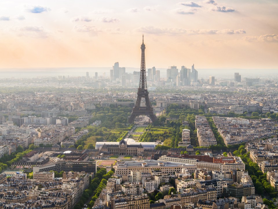 Aerial view of the Eiffel Tower and Paris skyline at sunset.