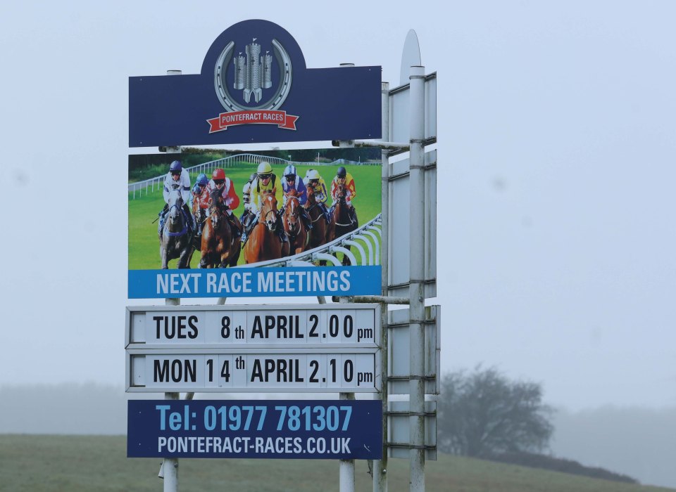 Pontefract Races sign showing upcoming race dates and contact information.