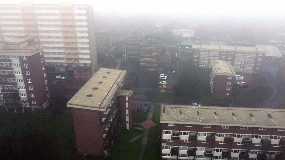 Aerial view of Pontefract, West Yorkshire, on a foggy day, showing several apartment buildings.